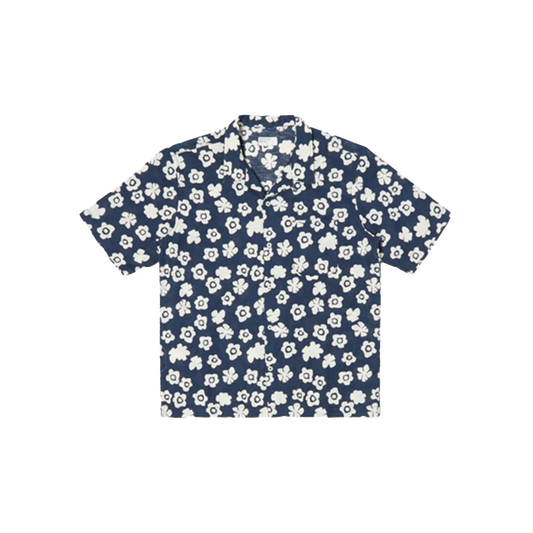 A Road Shirt by Universal Works, featuring an Indigo Flower design with short sleeves and a collar, displayed against a black background.