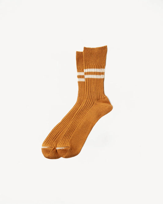 A pair of Hemp/Organic Cotton Stripe Socks in Sunset Gold with white double stripes near the top by RoToTo.