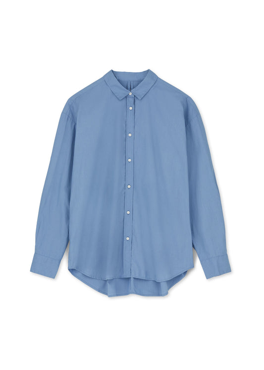 The Chetna Cotton Shirt by Aiayu, a relaxed fit light blue long-sleeve button-up shirt with a classic collar, made from GOTS-certified organic cotton, is displayed flat against a plain white background.