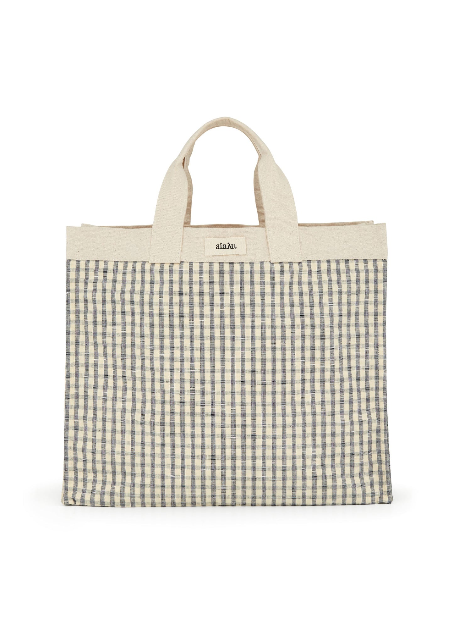 The Aiayu Shopper Check is a beige and black checkered shopper bag with short handles, made from 100% organic Chetna cotton, and features a small rectangular label near the top.