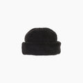 Discover the cozy Boa Toque by Cableami, a black fleece cap with a folded brim, elegantly displayed on a pristine white background.