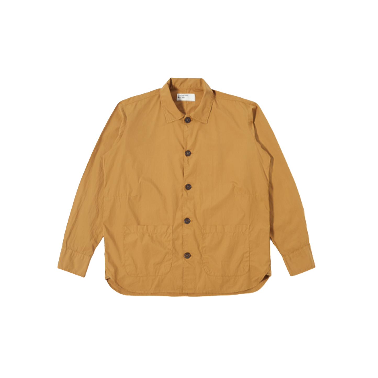 An oversized Travail Shirt in cumin by Universal Works with long sleeves, featuring a collar, two front pockets, and a stylish curved hem, displayed on a plain background.