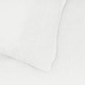 The Hawkins New York Standard Linen Pillow Case in white, part of a simple linen bedding ensemble, embodies understated elegance. Its European linen soft textures create a serene sleep environment.