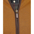 Close-up of a M Warm Pile Waistcoast Zip-In Liner by Barbour showing the zip-in zipper with a "Barbour" tag and part of a collared shirt inside.