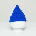 A Le Bonnet cobalt blue wool beanie, capturing Scotland's cozy charm, is displayed on a white mannequin head against a light grey background.