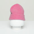 A pink, ribbed Beanie made from the softest wool by Le Bonnet is displayed on a white mannequin head against a plain background, proudly manufactured in Scotland.