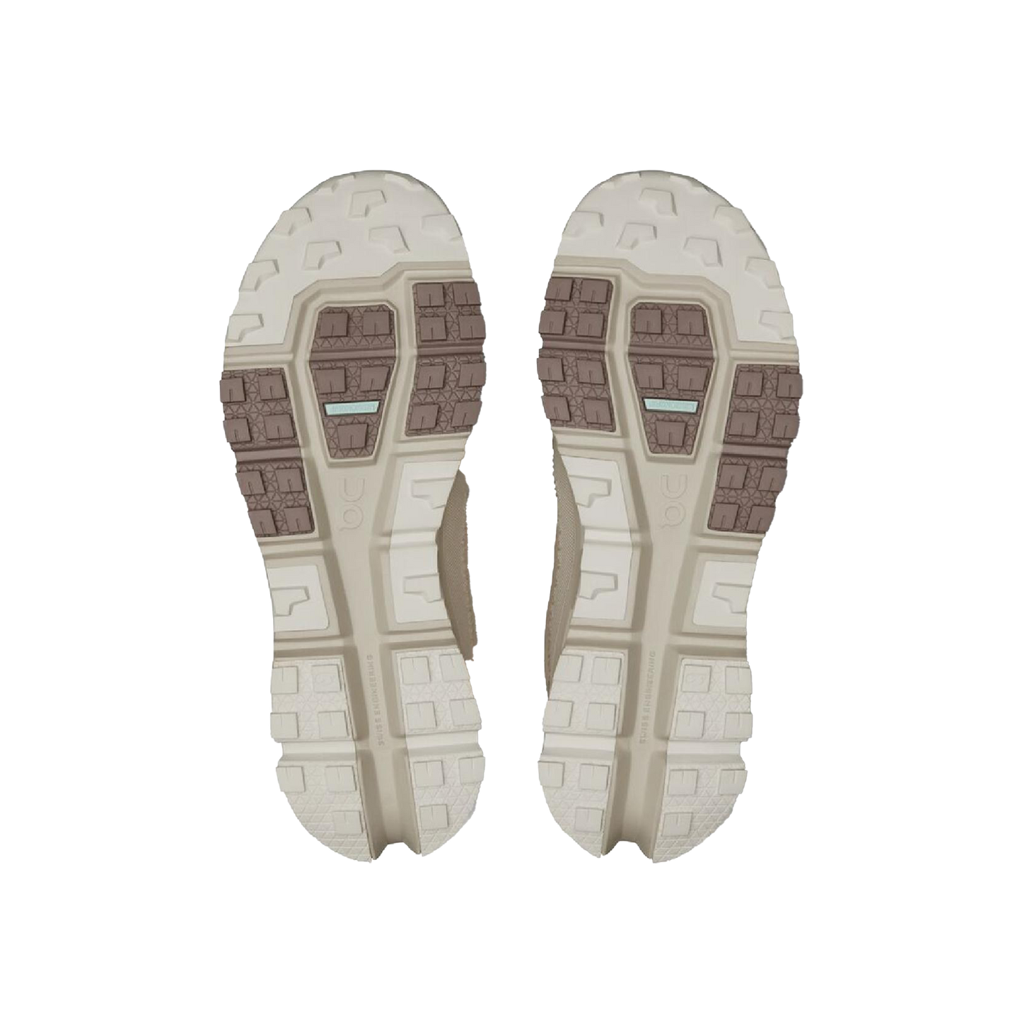 The image highlights the soles of On Running's Women's Cloudaway 2 shoes, displaying a textured pattern in beige and brown with rectangular and hexagonal shapes. The design is improved by the Missiongrip™ outsole for excellent traction and durability.