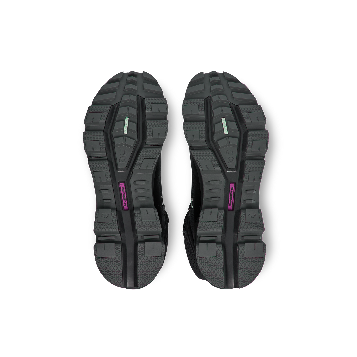 The image displays the black treaded soles of a pair of Women's Cloudrock 2 Waterproof athletic shoes by On Running, viewed from below, featuring colored accents in green and purple.