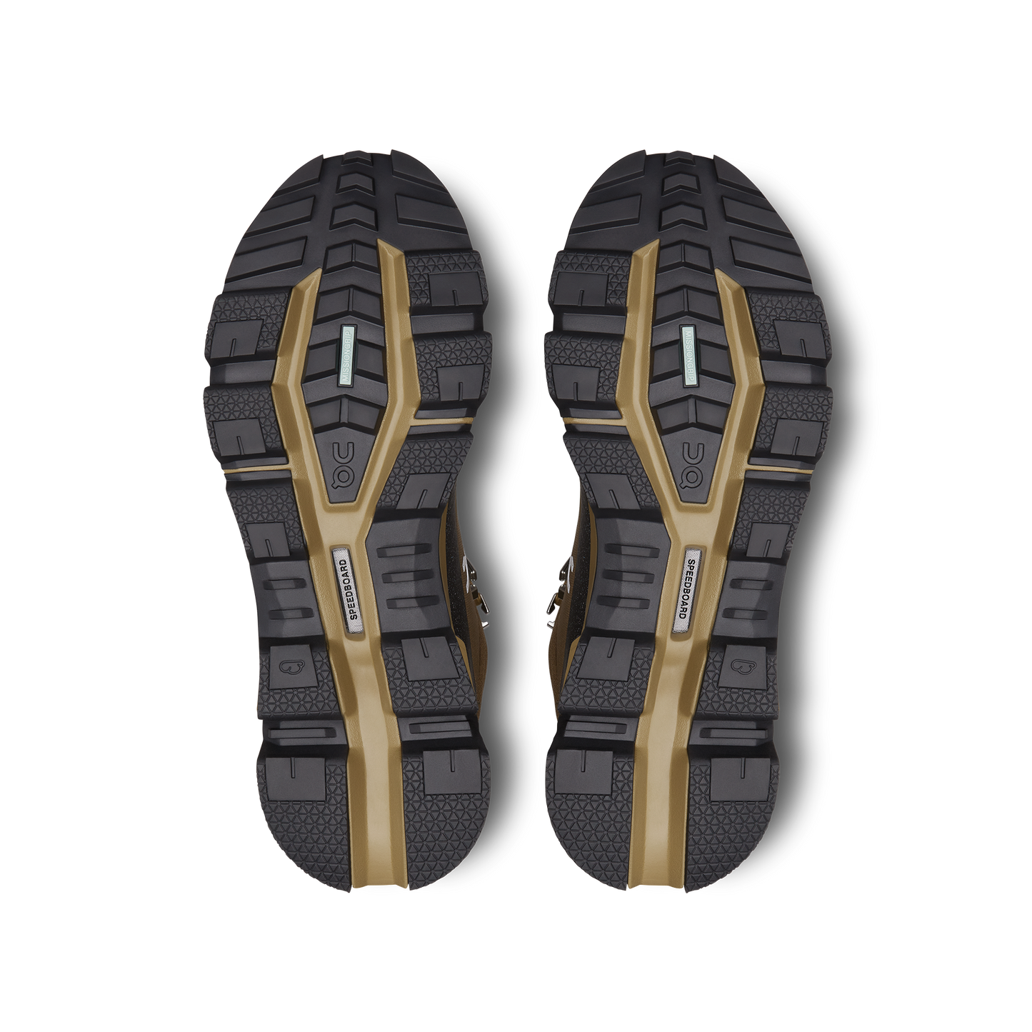 The image displays the expertly crafted shoe soles of the Women's Cloudrock 2 Waterproof by On Running, featuring black and brown hues with textured patterns and brand logos. These soles are specifically designed for speed-hiking boots, offering excellent shock absorption to ensure both durability and comfort on challenging terrains.