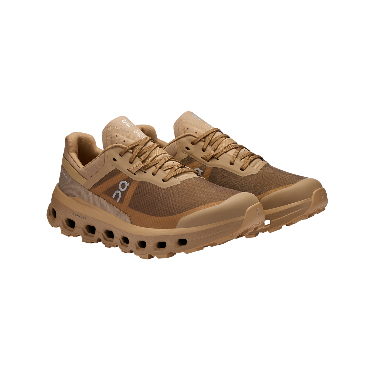 Men's Cloudvista 2 by On Running: An angled view of brown sports shoes with a mesh design, showcasing the exclusive Helion™ superfoam midsole for enhanced comfort and a cushioned sole.