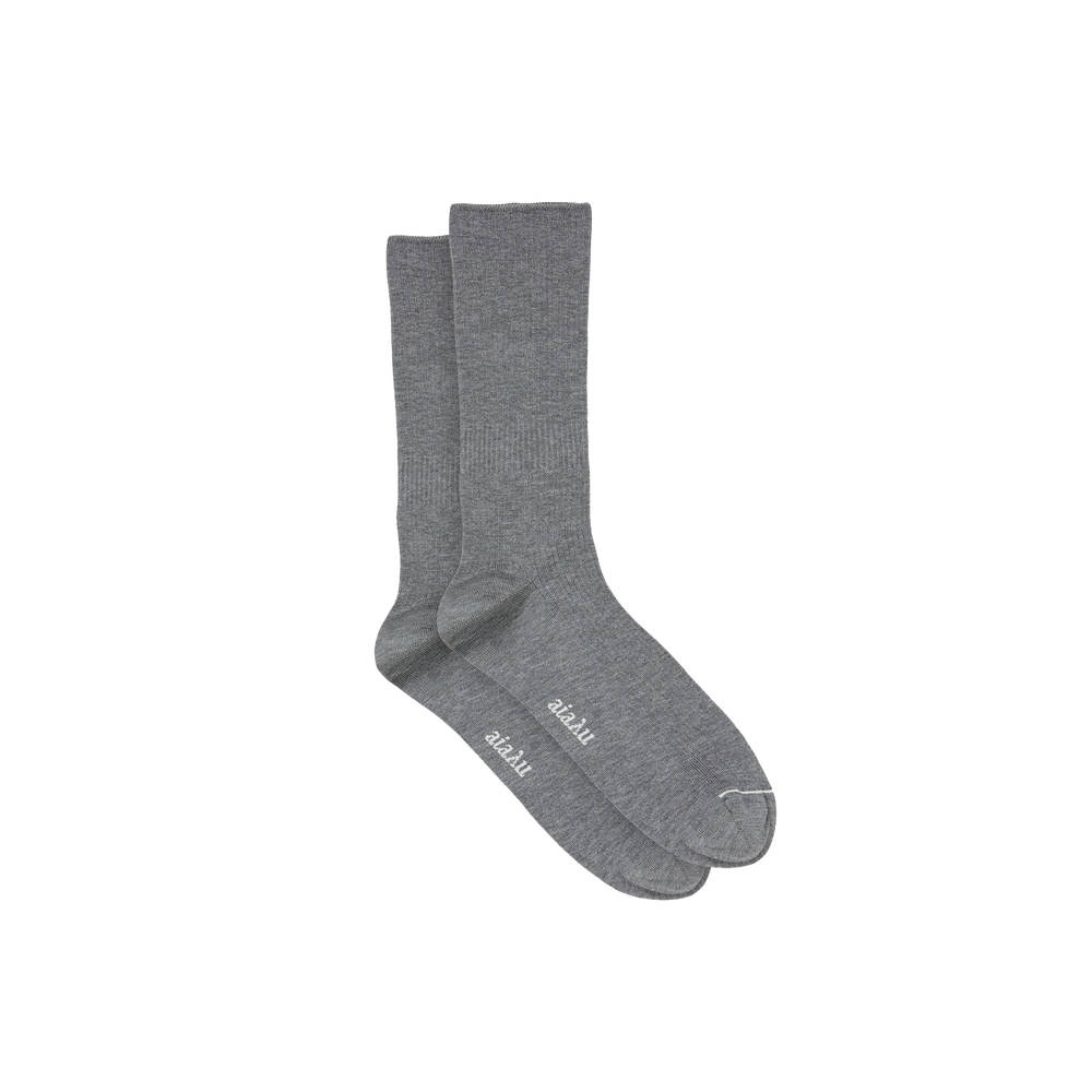 Two gray Aiayu Cotton Rib Socks, crafted from GOTS-certified organic cotton, feature "2basic" on the soles and are laid side by side against a plain backdrop.