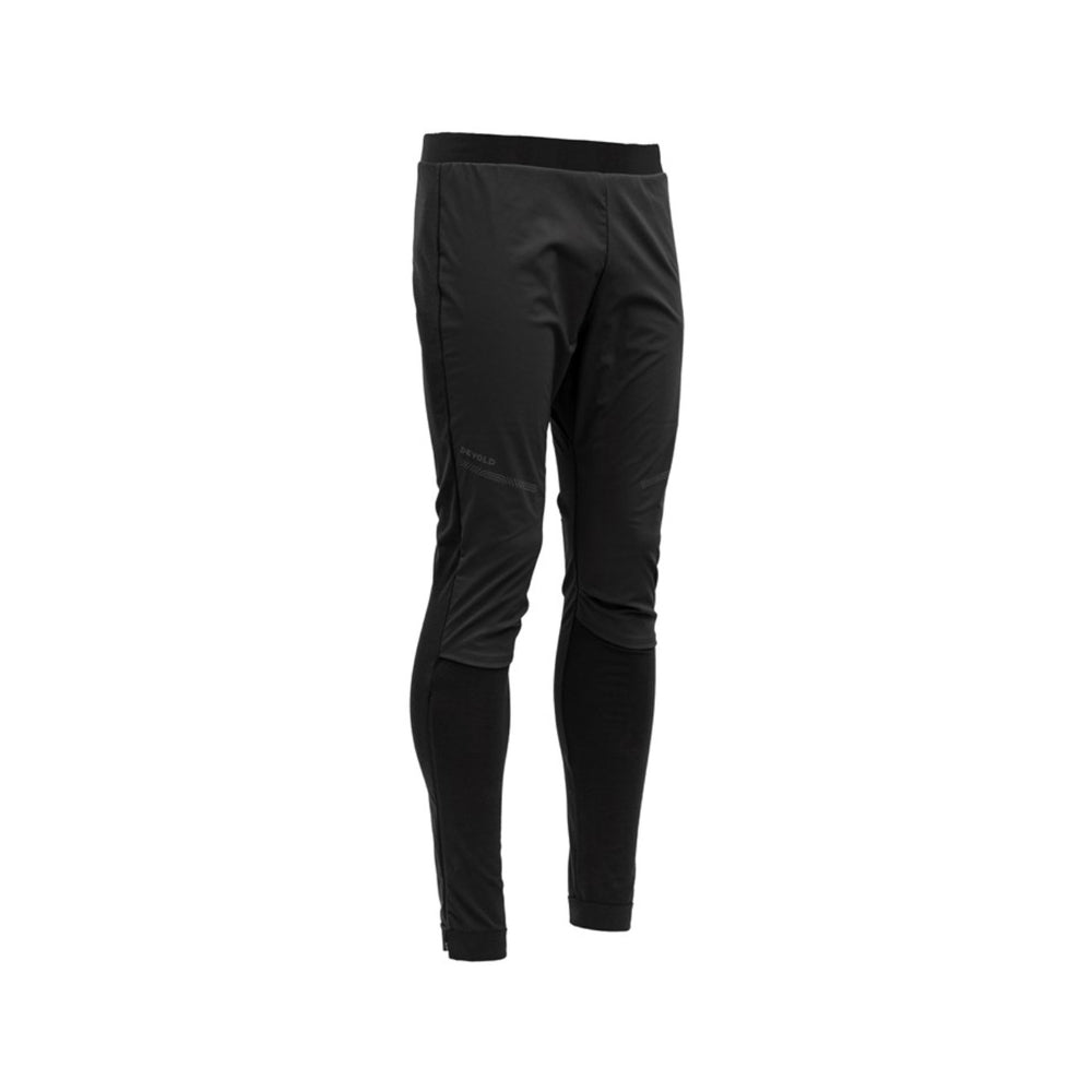 The Devold M Running Cover Pant, Caviar, features a sleek black design with an elastic waistband for a fitted athletic look. Its wind-resistant material stands out against a white background, highlighting practicality and style.