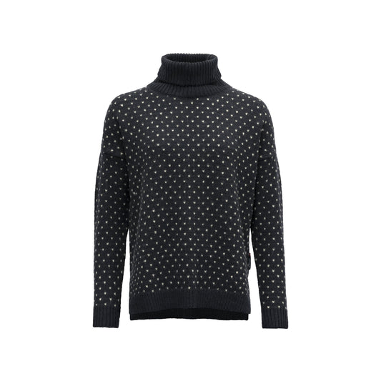 The W Sorisen Wool High Neck by Devold is a navy turtleneck sweater crafted from pure new wool, featuring a charming white polka dot pattern and a cozy loose fit.