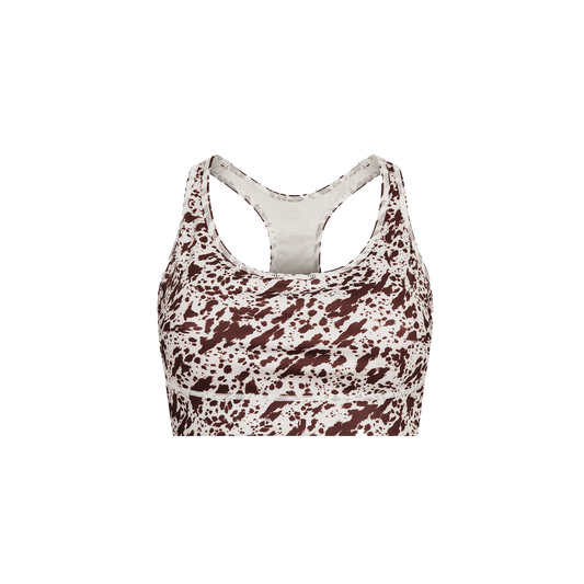 The Flattering Sports Bra by Rohnisch, featuring a moisture-wicking, racerback design with a brown and white speckled pattern, is displayed against a transparent background.