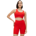 Dressed in a Rohnisch Flattering Sports Bra and matching shorts, the person stands confidently with one hand on their hip, gazing ahead. The moisture-wicking fabric ensures comfort as they pursue their fitness goals.