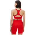 Person wearing a red athletic outfit with the Flattering Sports Bra by Rohnisch, viewed from the back.