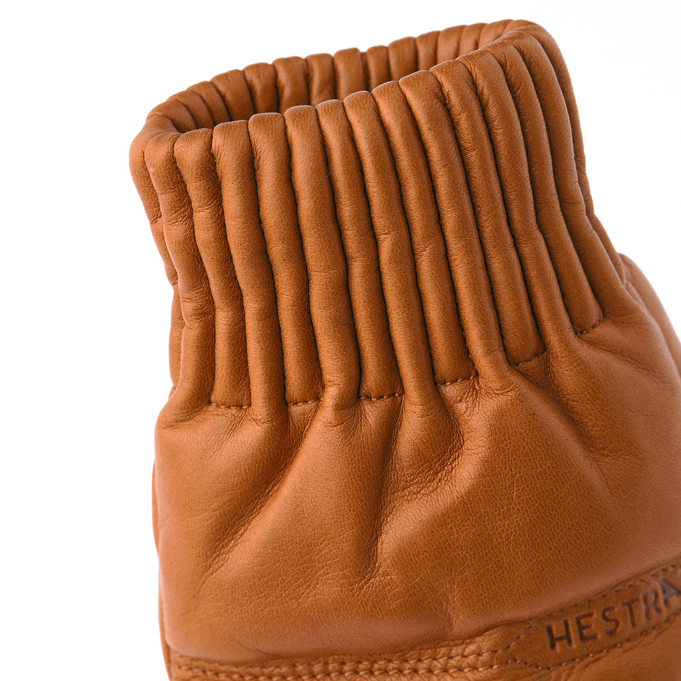 A close-up of the Hestra Valdres Mitten in Cork highlights its visible stitching and elastic cuff, blending style and durability.