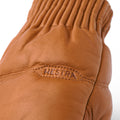 Close-up of a cork-colored Hestra Valdres Mitten made from luxurious Lamp nappa, with visible stitching and ridged wrist detailing.