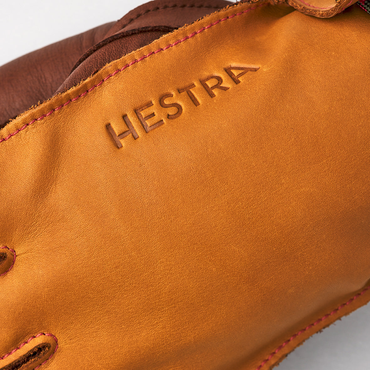 Close-up of a cork/brown Wakayama ski glove by Hestra, with the brand name embossed on the cuff and featuring removable liners for added comfort.