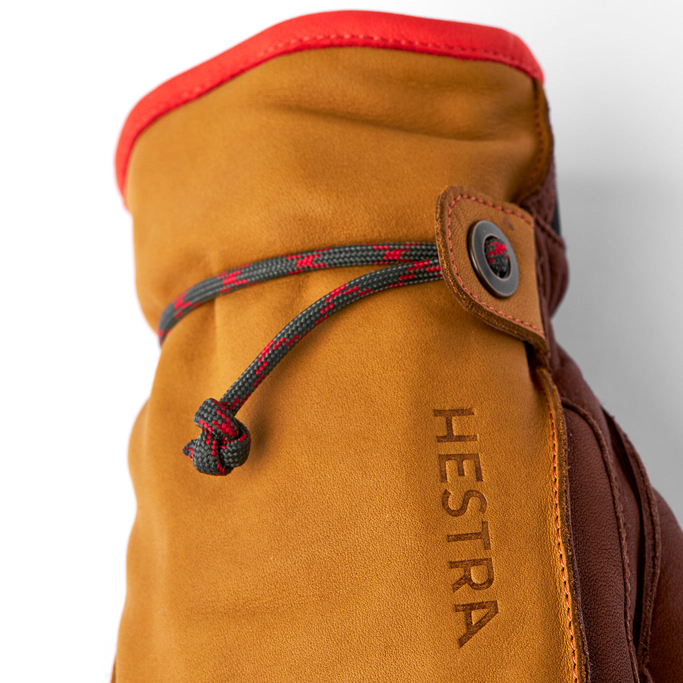 Close-up of a Hestra Wakayama glove in cork/brown, crafted from quality cowhide. It features removable liners, a drawstring for secure fastening, and the embossed brand name on the side.