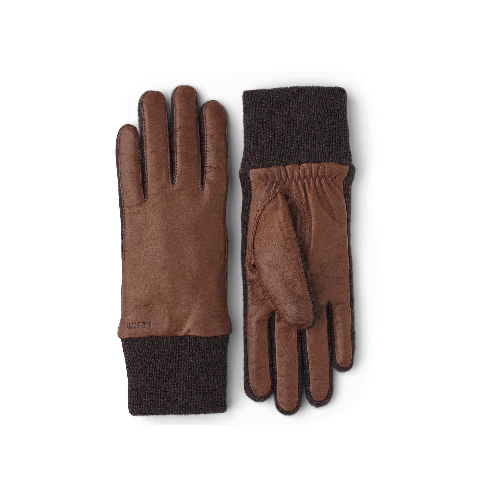 Hestra's Megan Gloves in Chestnut feature brown leather with black knit cuffs and a soft knitted lining. One glove is shown palm up and the other palm down on a white background.