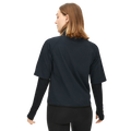 A person with shoulder-length hair, wearing a Rohnisch Insulate Padded Tee over a long-sleeve shirt made of recycled fabrics, is standing with their back to the camera.