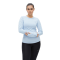 A person wearing the Rohnisch Jacquard Long Sleeve in a moisture-wicking, light blue material made from recycled polyester, paired with black pants, stands against a plain background.