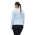 A person with a braid is seen from the back wearing a moisture-wicking light blue Rohnisch Jacquard Long Sleeve shirt and black pants.