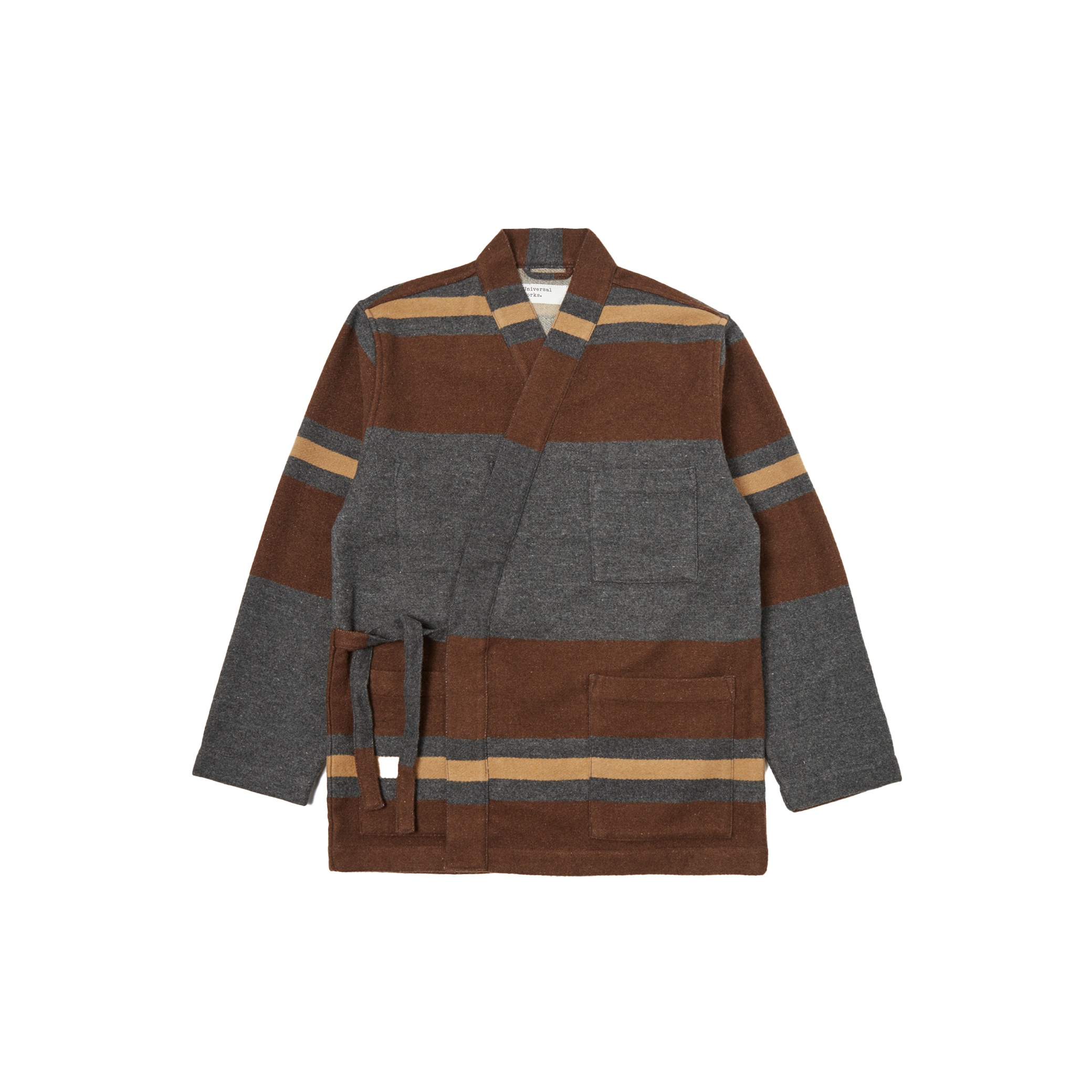 The Kyoto Work Jacket by Universal Works is a heritage-inspired piece, styled like a Japanese kimono jacket, showcasing a brown and gray stripe pattern. It includes a belt, long sleeves, and two front pockets.