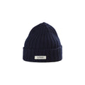 The Logo Beanie from Le Bonnet is a navy blue, ribbed knit design, featuring a folded brim and the iconic logo label for durability and breathability. Made in Scotland.