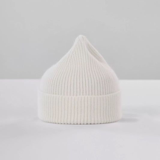 Le Bonnet's Beanie, Snow, is a white wool knit with a pointed top in classic Scottish style, shown on a simple gray backdrop.