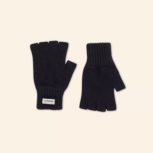 Crafted in Scotland from luxurious Merino wool, Le Bonnet's Midnight Fingerless Gloves feature ribbed cuffs and a label on one glove. Displayed on a light beige background, they offer style and comfort in black.