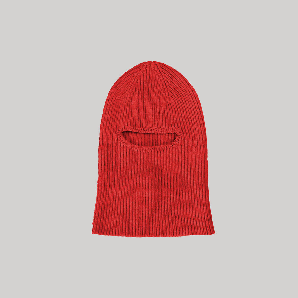 This limited edition balaclava from Le Bonnet, named Balaclava, Crimson, is made of luxurious cashmere and features a vibrant red color with eye and mouth openings.