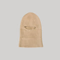 Le Bonnet's Balaclava in Sand, crafted from luxurious merino wool, features eye and mouth openings and is displayed on a plain gray background.