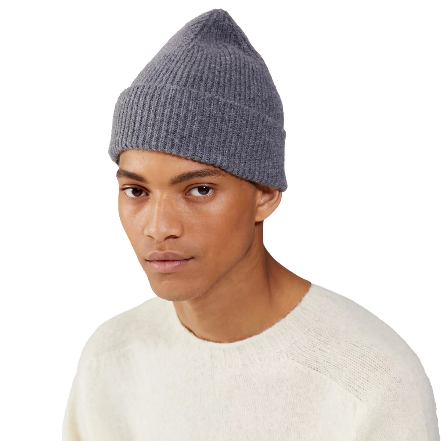 A person wearing a gray beanie from Le Bonnet and a cream sweater against a white background.