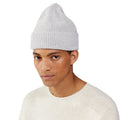 Model wearing a white Le Bonnet lambswool beanie and sweater, looking at the camera against a plain white background.