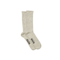 The Aiayu Llama Socks are a beige, unisex pair made from thermoregulating llama wool, featuring black text on the soles over a black background.