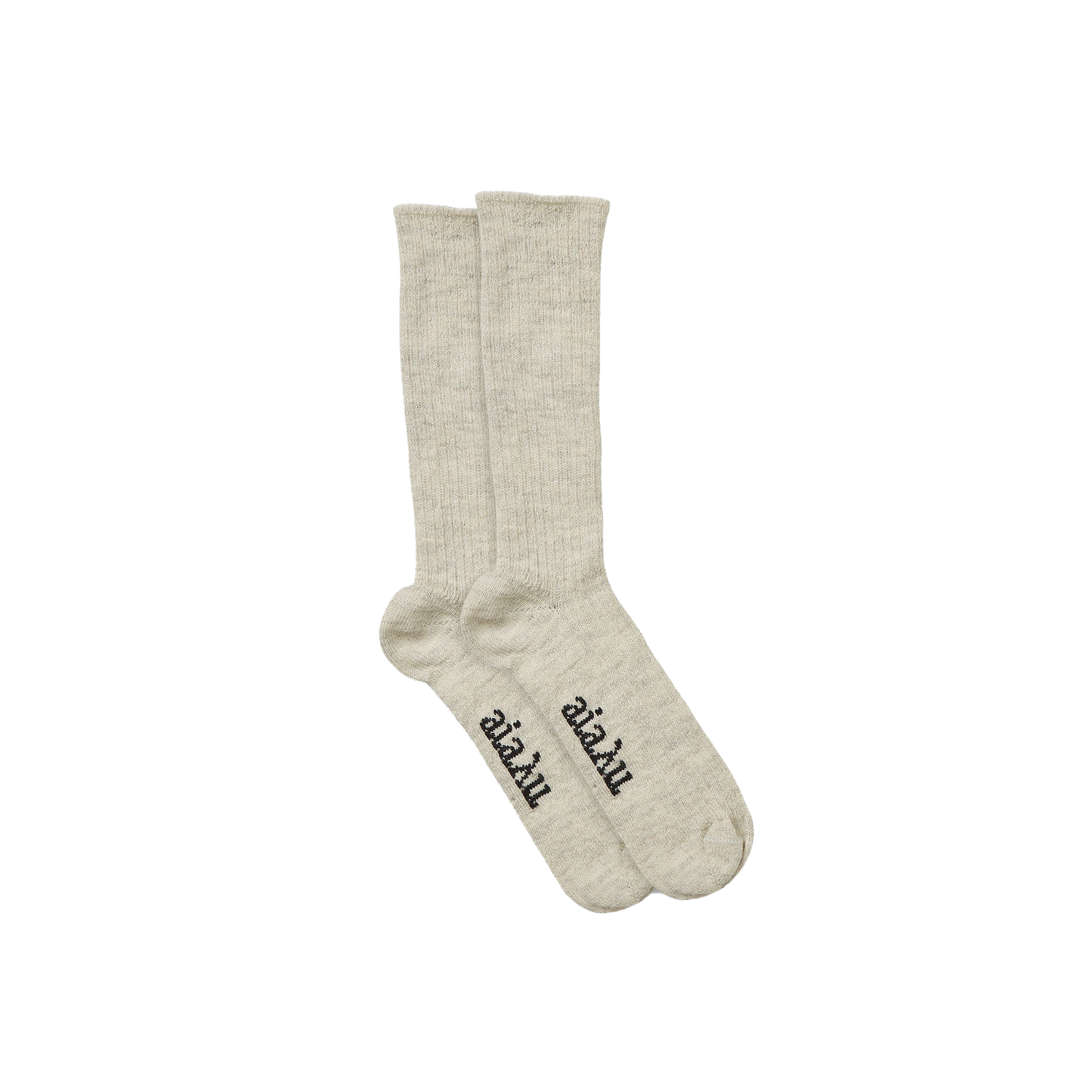 The Aiayu Llama Socks are a beige, unisex pair made from thermoregulating llama wool, featuring black text on the soles over a black background.