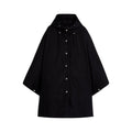 The Mackintosh W Boni cotton women's poncho, in sleek black, features snap buttons and side pockets. This weatherproof essential is displayed flat against a white background, highlighting its elegant design.