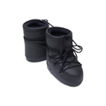 The Icon Low Rubber in black by Moon Boot, featuring a quilted design and lace-up front reminiscent of astronaut gear, is shown against a white background.