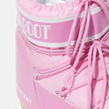 Close-up of the Moon Boot Icon Low Nylon in pink, highlighted by white trim, laces, and the iconic "MOON BOOT" text on the upper part, renowned for its insulated footwear design.