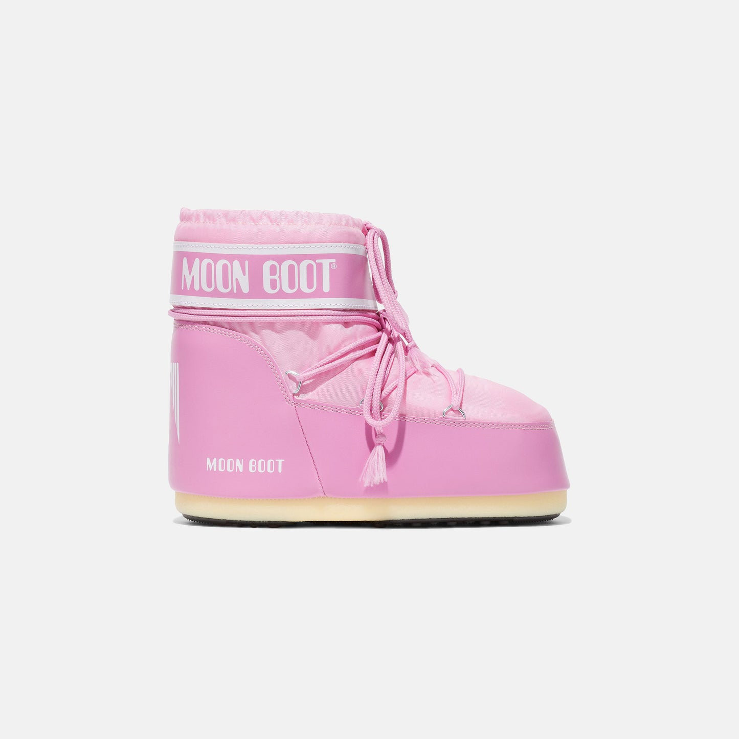 Moon Boot's Icon Low Nylon, Pink boots are inspired by astronaut gear and feature a flat sole and lace-up design on a white background.