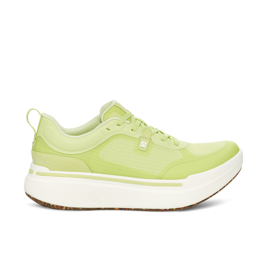 The AHNU M Sequence Low in Lime is a sleek sneaker with a white sole, lace-up design, and a pull tab at the back. This model incorporates advanced PEBA foam for superior comfort.