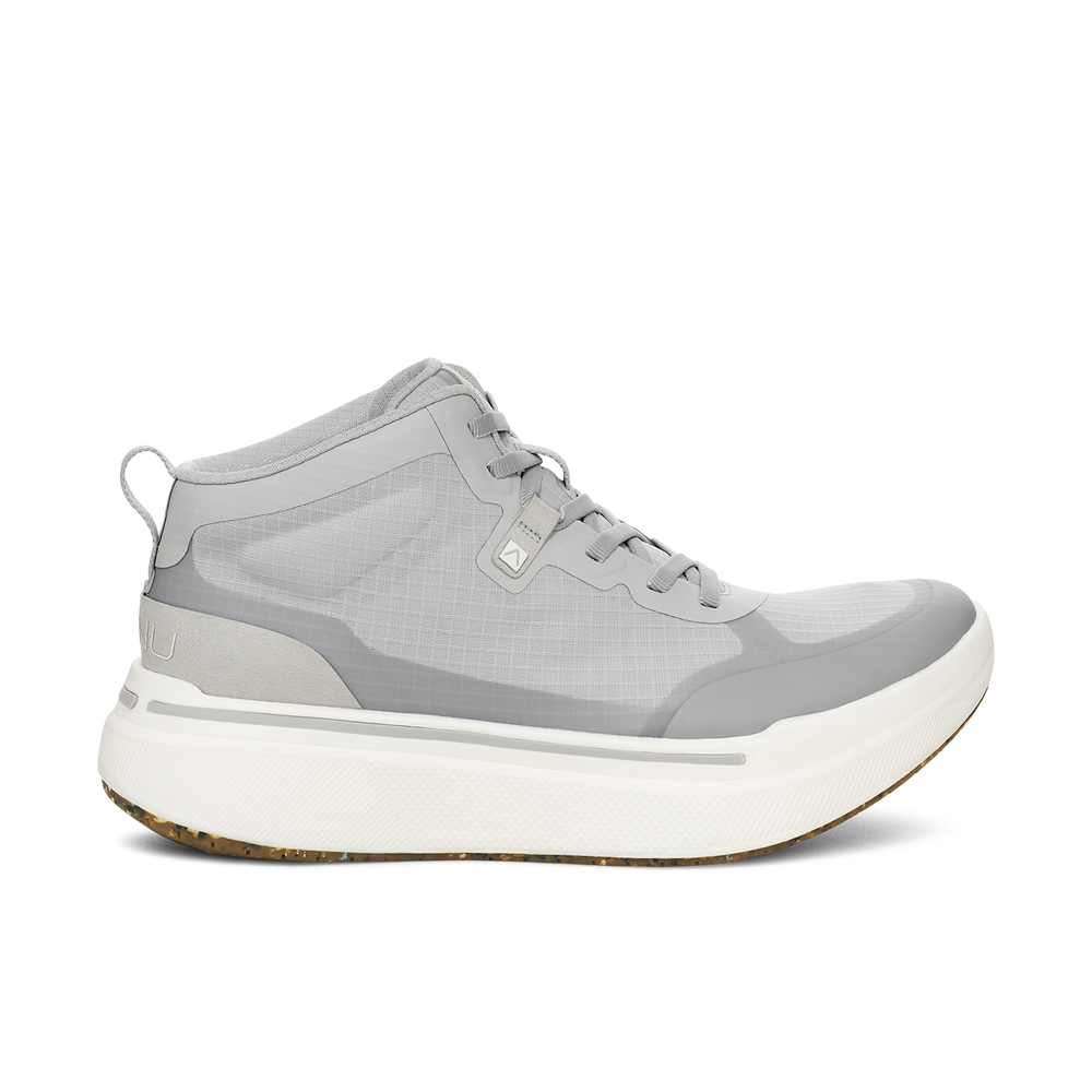 The M Sequence Mid, Grey by AHNU is a high-top sneaker in gray with white soles and a convenient pull tab at the heel. It features mesh fabric combined with synthetic overlays, and includes a white midsole infused with PEBA foam and a textured outsole for enhanced comfort and performance.