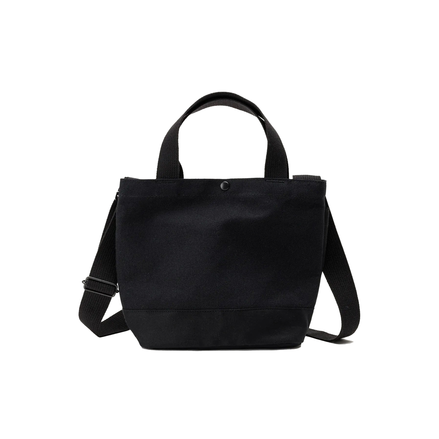 The New York Tote Small by Bags in Progress is a black cotton canvas bag made in Japan, featuring short handles, a detachable shoulder strap, and a button closure at the top.