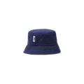 The Mackintosh Pelting Bucket Hat, made from dry wax cotton in navy blue, features a small white rectangular patch with an icon and text. Two metal eyelets on each side enhance its functionality. Water-repellent and stylish, it stands out against a plain white background.