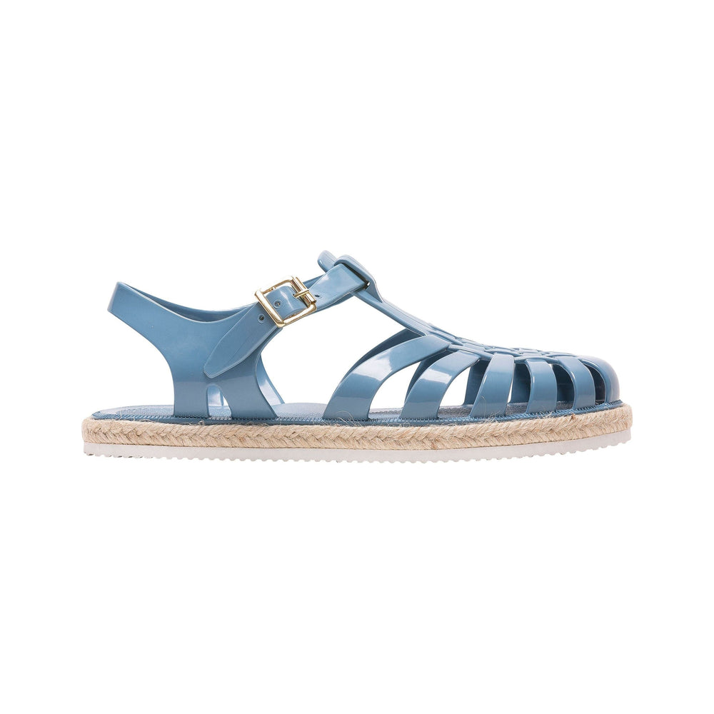 A side view of Meduse's Suncorde, Denim strappy sandal with a gold buckle and a woven sole.