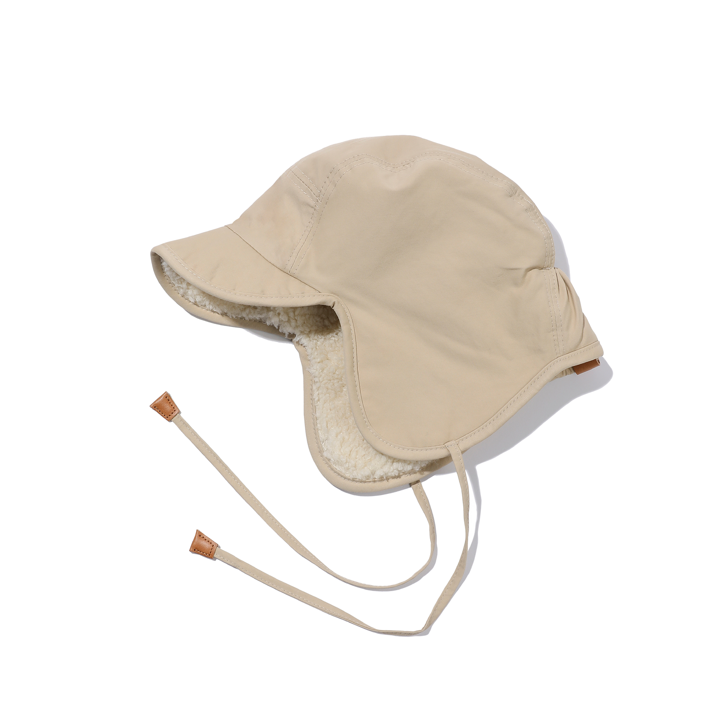 Introducing the Kappy Reversible Trooper Hat, a timeless winter essential in a beige hue. This versatile accessory features ear flaps, cozy fleece lining, and adjustable chin straps to provide warmth and style for everyone.