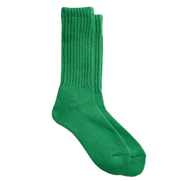 A pair of Loose Pile Crew Socks in green by RoToTo displayed against a white background.