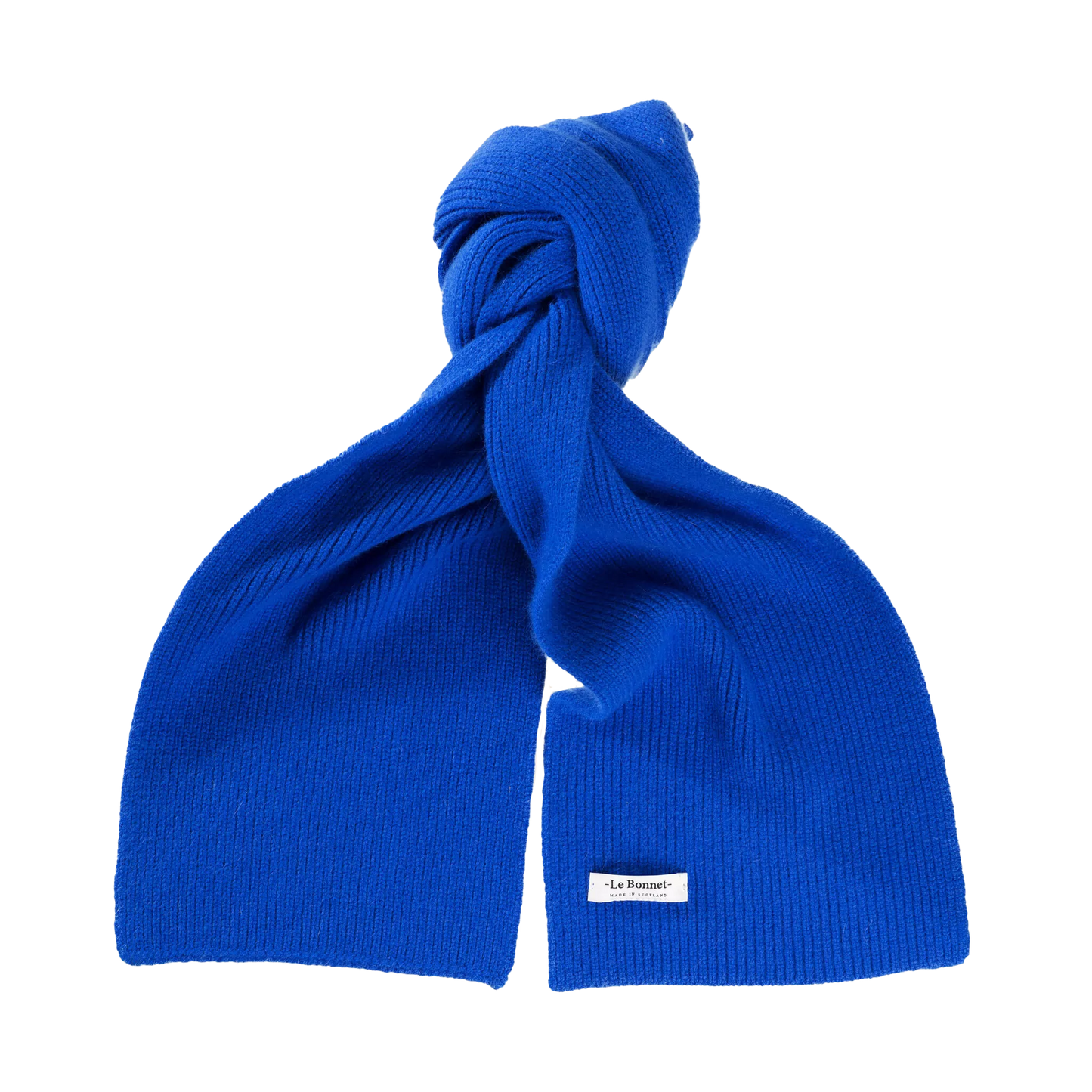 A vibrant blue lambswool scarf from Le Bonnet, crafted in Scotland and tied in a loose knot, featuring a small rectangular label attached near the bottom.